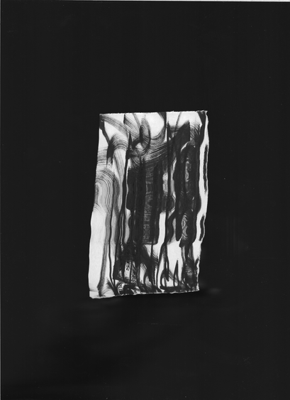 Abstract black-and-white artwork featuring a rectangular piece of paper centered on a dark background. The paper is covered with fluid, vertical black ink streaks and distorted lines, creating a dripping or melting effect.