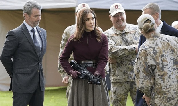 Pics from Mary and Frederik's Latvia state visit day 2: Mary holds a gun, Fred wears fatigues, the couple eat with the troops and attend reception at the National Art Museum