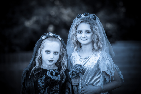 Spooky picture of two kids in Halloween costume.