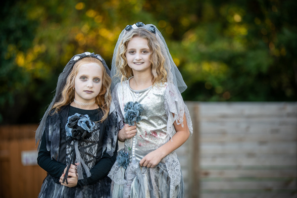 Spooky picture of two kids in Halloween costume.