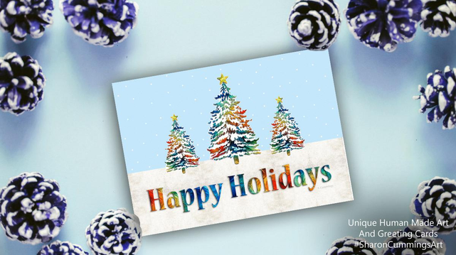 Colorful holiday card with trees, snow and a blue sky by artist Sharon Cummings.