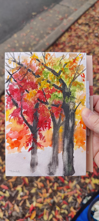Three autumnal colored trees in watercolor.