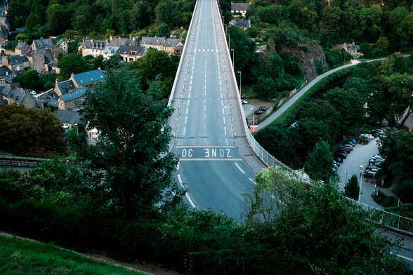 An empty road on a massive bridge going over a rural valley