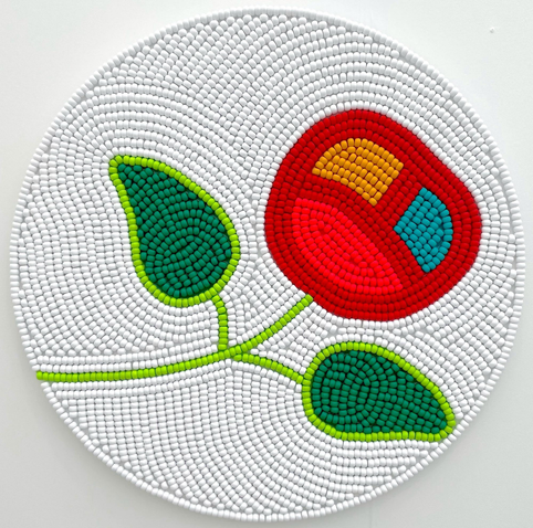 a round wooden bead piece by Renee Condo of a cherry like form on white