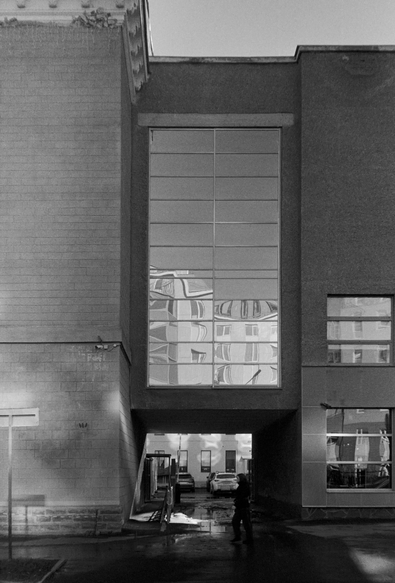 A modern building with a vertical block of reflective glass.