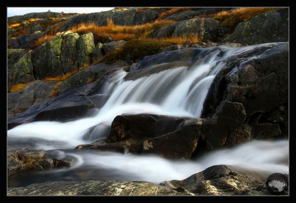 Mountain stream flowing through the rocks. Autumn.