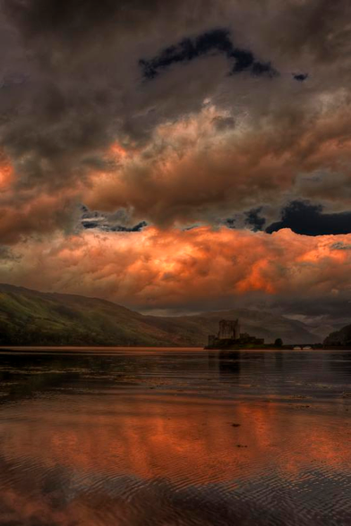 Orange clouds reflecting in the water below.