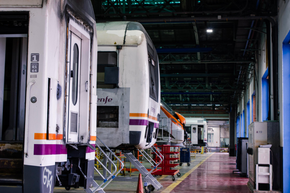 The side view of a row of different EMUs. There are several cars from the Renfe class 448 EMUs, as well as a Civia driving cab.