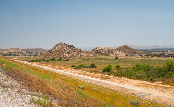 Arid hills below the long Lake Perris dam