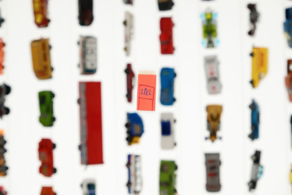 toy cars hanging from the ceiling, label "target" on the wall
