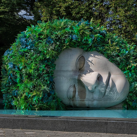 “The Weeper” sculpture of a head of an angel resting on water surface in The Hakone Open-Air Museum by François-Xavier Lalanne in Hakone Open-Air Museum Museum
