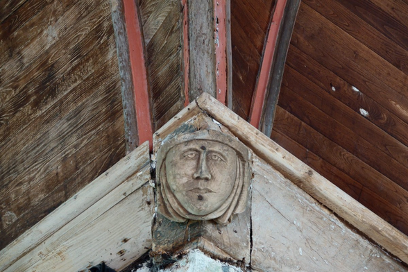 A sculpted head on a ceiling