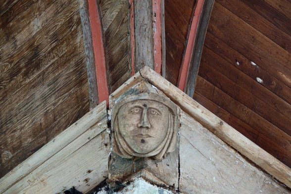 A sculpted head on a ceiling 