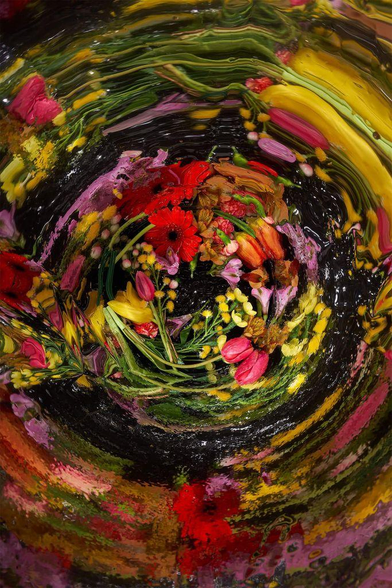 Vibrant flowers swirl in water, creating a colorful, distorted underwater effect, with reds, pinks, and yellows against a dark background.
