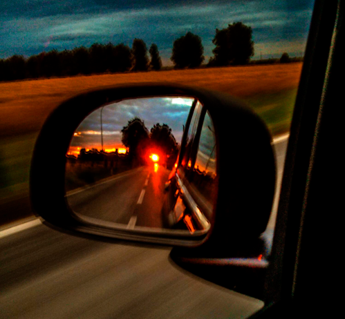 This photo shows a car’s mirror. You can see the road, a part of the car and the sunset at the very end of the landscape. Colours are warm, mainly orange. I wanted to symbolise the past and, if you look back, you can find some light even if you didn’t expect to see it