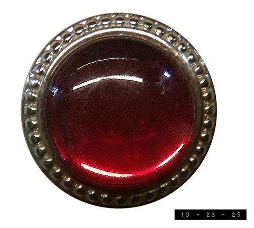 A vintage ruby red earring with fancy metal trim.  Might be the right one.  Might be the left one.  Each one is more than an inch in diameter.  Which seems rather large to me and is why I thought they must be clip-ons, but nope - the single post means they were made for pierced ears.  Of which I have zero.  Perhaps I'll donate them to the local cat shelter . . . .     