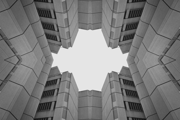 An. abstract black and white symmetrical architecture photo of a brutalist building.