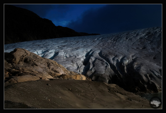 One ray of light between the dark clouds. Folgefonna National Park on morning. Folgefonna Glacier.