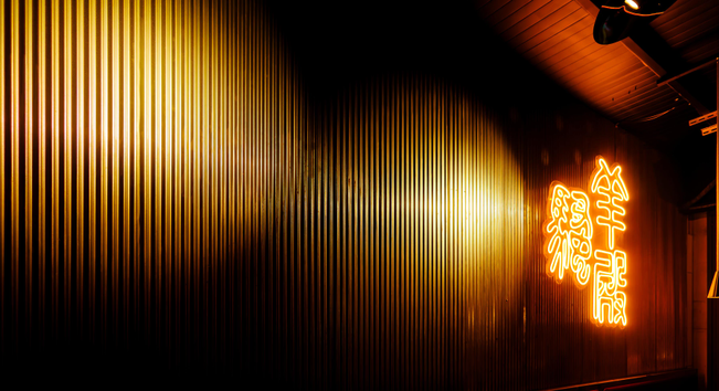 Illuminated interior wall with the name of the restaurant in neon hanzi.