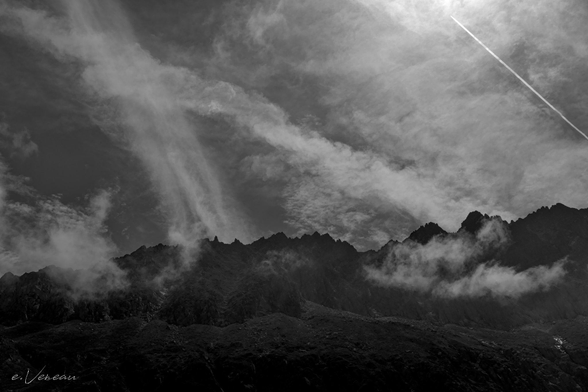 Clouds clinging to the top of a mountain.