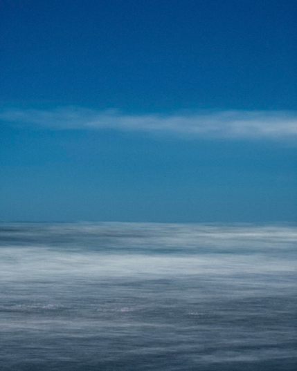 Impressionistic, colour landscape photograph with intentional camera movement (ICM) of the sea with white cloud

Photography by Al Keddie