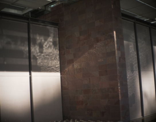 Reflection of water and siver balls on a wall