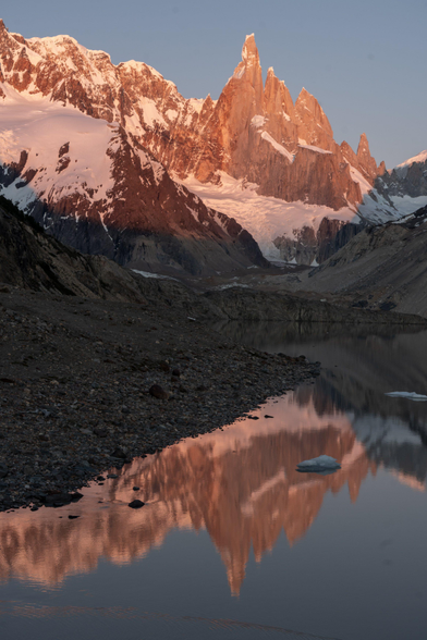 Cerro Torre eastern face reflects the sunrise onto Laguna Torre lake