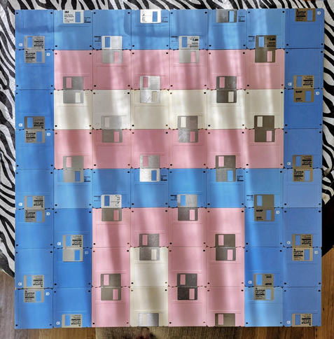 3.5" floppy disks arranged in a manner to resemble the Transgender Pride Flag