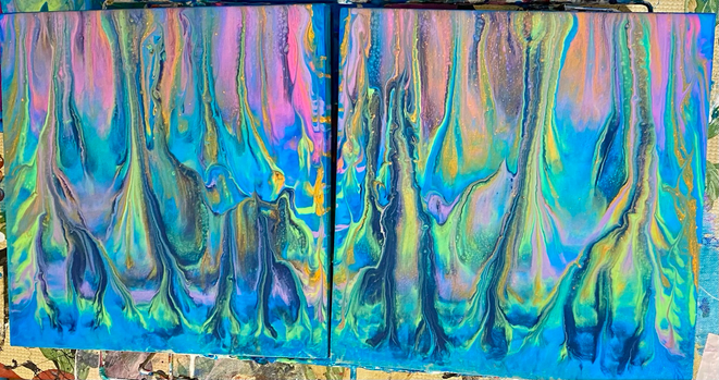 Two square wooden pieces with a surreal explosion of colors that kinda looks like a spooky neon forest, or maybe a swamp with northern lights. 