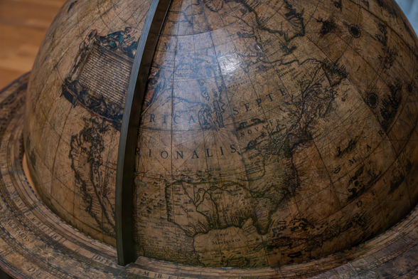 A photo showing the detail of North America on an antique globe, with much of the continent missing as it had not yet been mapped by Europeans.
