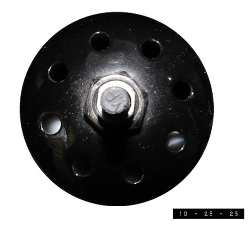 Vented black metal back side of a light on a pole lamp.  It is one of three swivel lights on the lamp and measures about 2.25" in diameter.   The rotary switch in the center turns it on and off.   The "YF" on the switch is probably the initials of the manufacturer but the paranoid in me suspects it might be the lamp telling me "You're fat!"  But I'm *not* fat!  Not really.  Not by much, anyway.  And I look even thinner with the light turned off.  