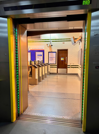 Tube station exit and entry barriers outside lift that takes passengers to platforms 