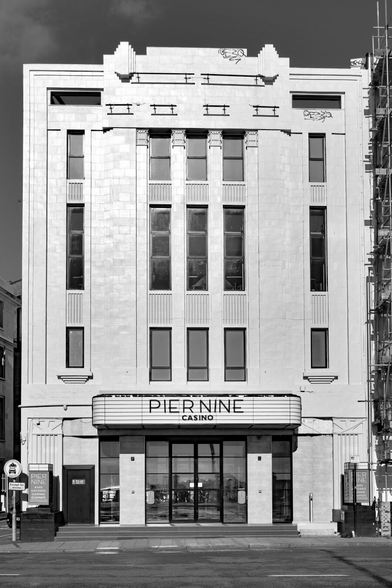 Monochrome photo of the south façade of Pier Nine Casino which now occupies the Art Deco building designed by W.R.Glen, opened 1930 as the Savoy Cinema. Grand Junction Road, City of Brighton & Hove, UK.