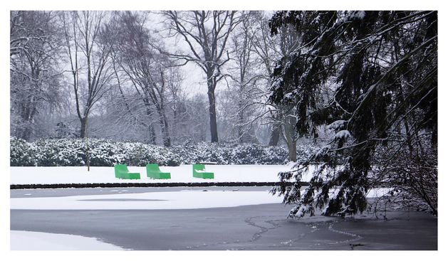 Photo of some green seats in a monochrome winter landscape