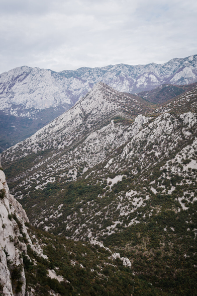 Limestone mountains. At the foot of the mountains, there are expanses of trees, and the mountains appear as if they were covered in snow, but this is their natural white color.