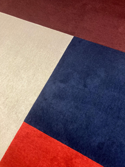 Four differently-colored segments of carpeting at work.