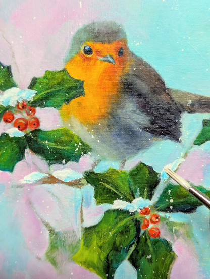 More progress in my new painting of a Robin sitting on a holly branch, surrounded by green leaves and red berries, adding some white color for snow and snowflakes, by Karen Kaspar