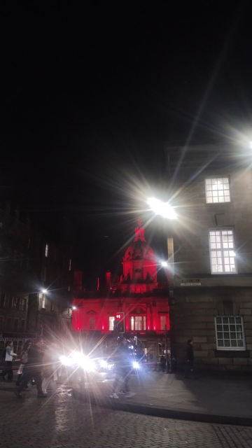 The dome of the Bank of Scotland at night, lit poppy red to mark Remembrance Sunday