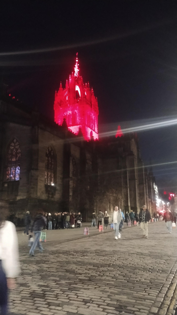 Saint Giles Cathedral on the Royal Mile at night, the tower lit poppy red to mark Remembrance Sunday