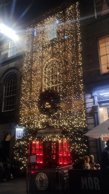 Piper's Rest restaurant at night, the front of the old building covered by a net of twinkling lights