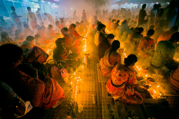 Hindu devotees offer prayers to Baba Lokenath at the Ashram temple.