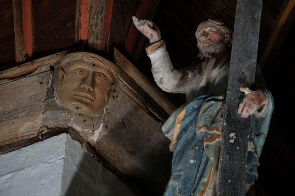 A mask and a sculpture of Jesus