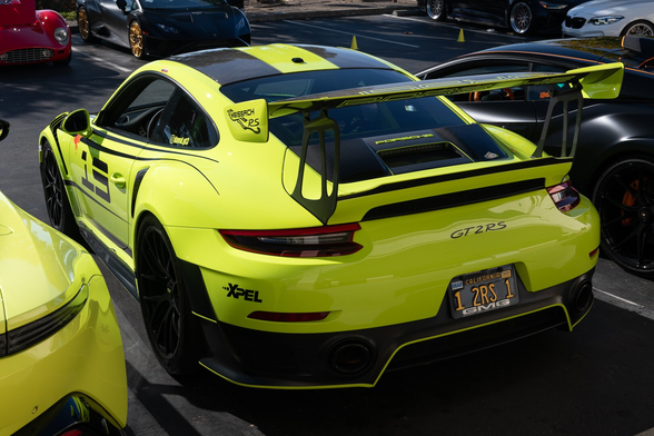 A bright highlighter green sports coupe with a large wing.