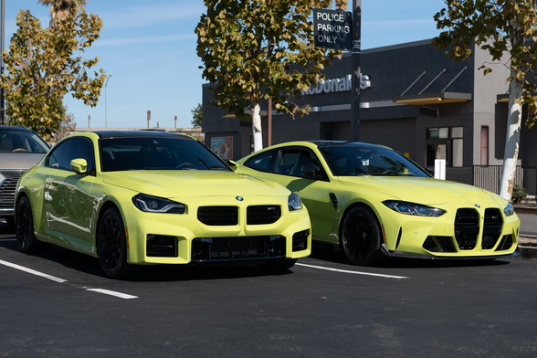 Two sports coupes in greenish-yellow shades.