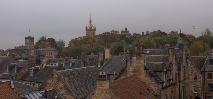 Red rooves and autumn trees with Linllithgow Palace in the background