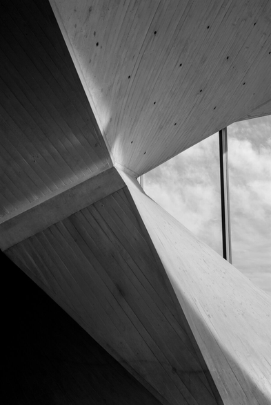 A black and white photo of one of the interior columns at St Mary's cathedral in San Francisco. It's so close-up it's almost abstract, with dark shadows highlighting the curved concrete.