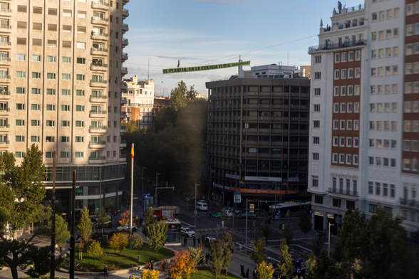 A Greenpeace activist with a banner bearing the slogan ‘The planet on a tightrope’ walks along a highline 30 metres above the Spanish capital. 