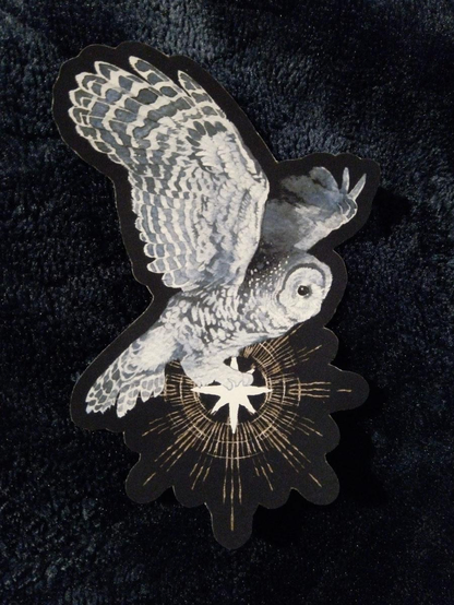 sticker featuring art of an owl holding a star while flying
