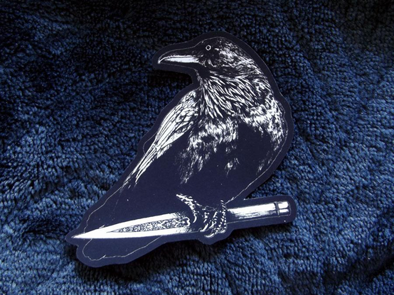 sticker featuring art of a crow holding a dagger
