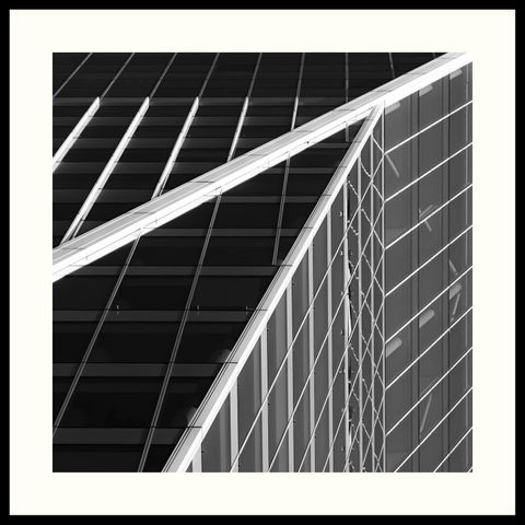 b&w - Close-up of the Haagsche Zwaan, one of the many modern office buildings in The Hague. A steel and glass design where the metal parts are light-coloured and the glass is dark-tinted.